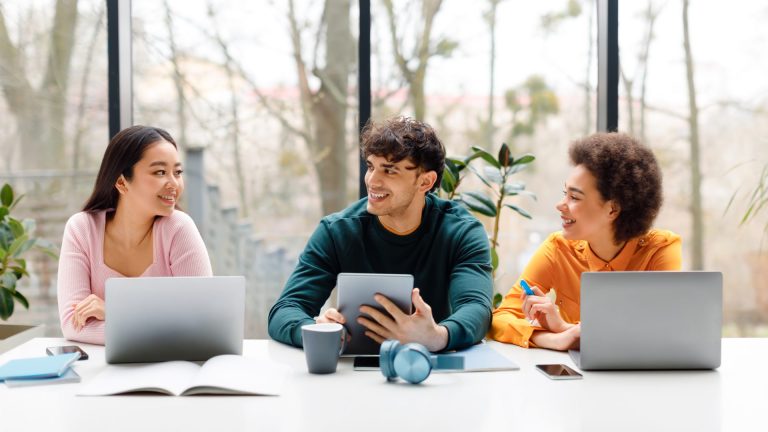 happy-diverse-three-students-using-various-gadgets-2023-08-30-02-43-09-utc